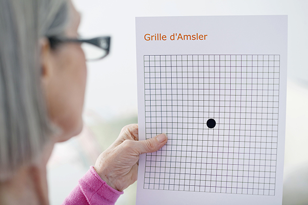 Woman testing her vision with an Amsler Grid